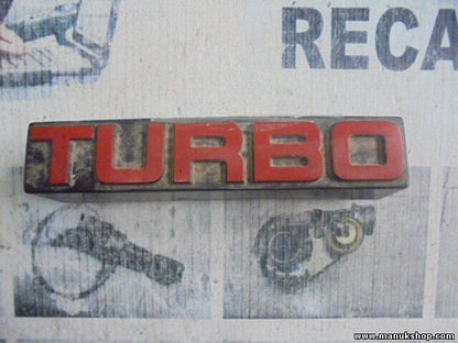 Emblema Nissan Terrano WD21 Ford Maverick TURBO 6289785G10