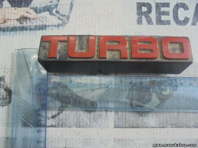 Emblema Nissan Terrano WD21 Ford Maverick TURBO 6289785G10