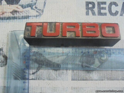 Emblema Nissan Terrano WD21 Ford Maverick TURBO 6289785G10